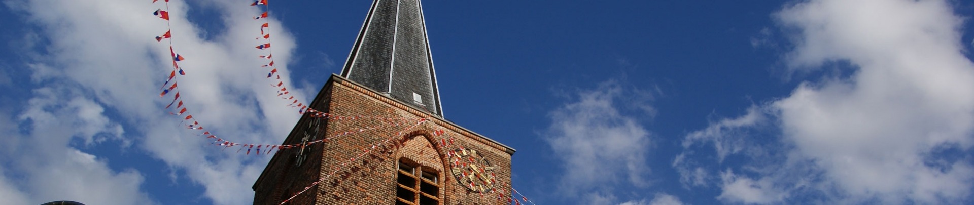 Kerktoren versierd met vlaggetjes